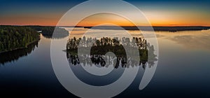 Suoyarvi lake at sunrise surrounded by forests of Karelia