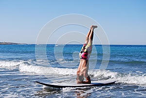 Man in headstand on SUP