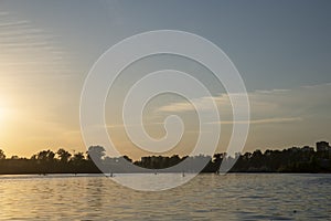 SUP Surfers At Sunrise on lake near city