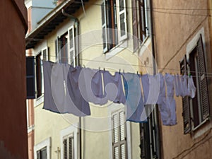 Supended laundry in a street of Trastevere to Rome in Italy.