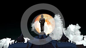 Super blood moon rise on the night sky and white cloud moving pass buddha standing