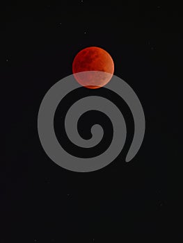 Super blue blood moon with total lunar eclipse over dark sky background