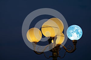 Super blue moon back on light pole in night sky