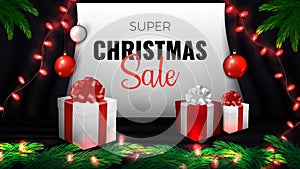 Super Christmas Sale Banner. Red and white gift boxes, red garland, pine branches and balls on black curtain background