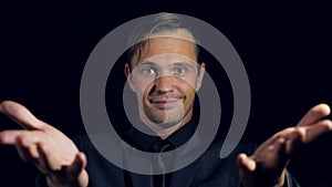 Super close-up of a man in black clothes on a black background. 4k. Slow motion.