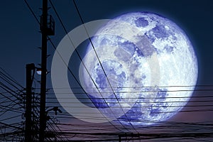 Super dark blue moon back silhouette power electric line on night sky