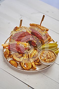 Super deluxe tasty grilled reuben sandwiches with pastrami meat, cheddar cheese