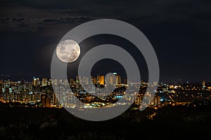 Super full moon over Ribeirao Preto City at night, Brazil Countryside