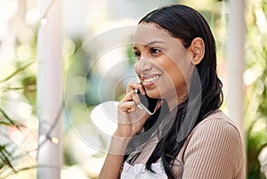 Super happy to place your order. a young florist using her smartphone to make a call.