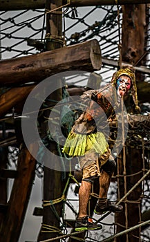 Super hero Competitor 2014 Tough guy obstacle race in fancy dress hanging on ropes