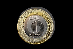 One Saudi Arabian Riyal Coin Isolated On A Black Background photo