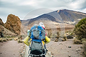 Super Mom with baby boy hiking in backpack