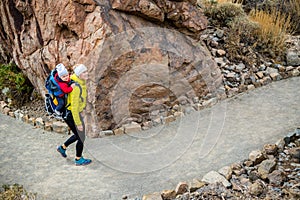 Super Mom with baby boy hiking in backpack