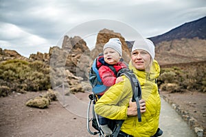 Super Mom with baby boy hiking in backpack