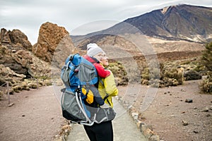 Super Mom with baby boy hiking in backpack