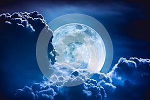 Super moon. Nighttime sky with clouds and bright full moon with