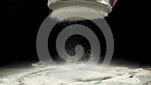 Super slow motion for baking flour is sifted through a sieve. Filmed on a high-speed camera at 1000 fps.