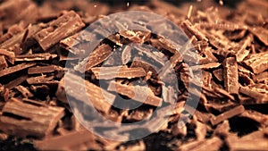 Super slow motion falling of grated milk chocolate. Filmed on a high-speed camera at 1000 fps.