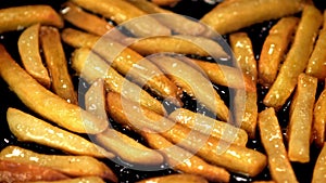 Super slow motion of fries is fried in a frying pan with bubbles of oil. Filmed on a high-speed camera at 1000 fps.
