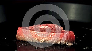 Super slow motion tuna steak is fried in a frying pan.Filmed on a high-speed camera at 1000 fps.