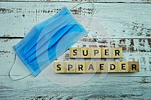 Super Spreader word letter on wooden background