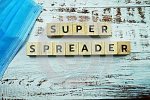 Super Spreader word letter on wooden background