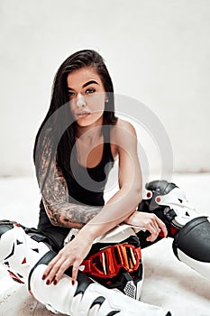 Super stylish brunette in a tracksuit posing in a white photo studio