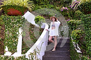 superb model sits on steps of stone staircase inside patio in Spa hotel