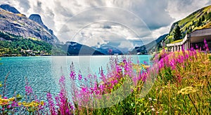 Superb morning view of Fedaia lake. Wonderful summer scene of Dolomiti Alps, Gran Poz location, Trentino-Alto Adige/Sudtirol regio