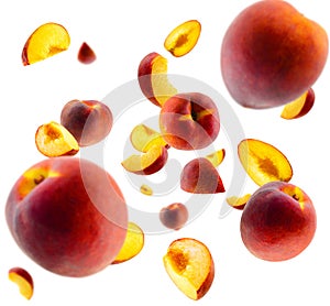 Superbly retouched whole peaches and slices fly and levitate in space. Selective focus. Isolated on white