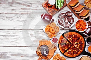 Superbowl or football theme food side border on a white wood background