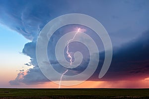 Supercell thunderstorm cumulonimbus cloud with lightning bolt