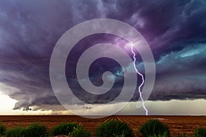 Supercell thunderstorm with dark clouds and lightning.