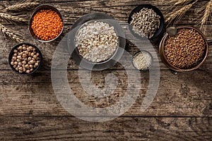 Superfoods and cereals selection in bowls, chickpeas, lentils, buckwheat, oatmeal, flax seeds, sunflower seeds