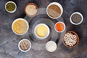 Superfoods and cereals selection in bowls on grey concrete background