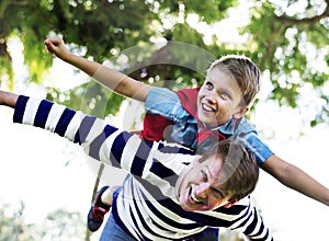 Superhero boy flying on the back of his dad