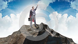 The superhero businessman on top of mountain