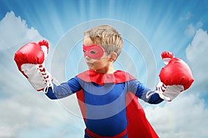 Superhero child with boxing gloves