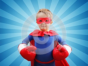 Superhero child with boxing gloves