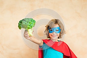 Superhero child eating superfood photo