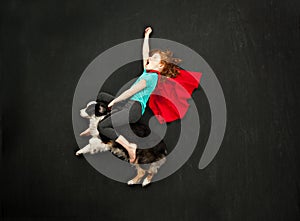 Superhero girl riding her dog