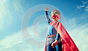 Superhero kid in red cape and mask
