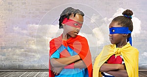 Superhero kids with cloudy sky wall