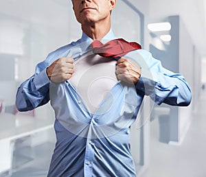 Superhero. Mature businessman tearing his shirt off