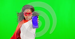 Superhero, phone and mockup with a girl on a green screen background in studio for marketing or advertising. Kids