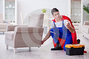 The superhero repairman with tools in repair concept