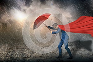 Superhero standing holding red umbrella protection,rain and storm,sky and black cloud,city background,with business,insurance,