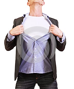 Superhero. Young man tearing his shirt off isolated on