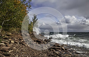 Superior lake shore with waves hitting rocks.