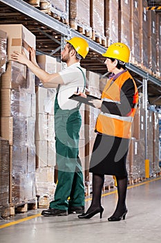 Superior and worker in warehouse